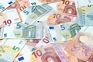 Stack of five and ten euro banknotes background.