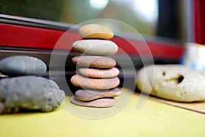 Stack of flat stones balanced on a windowsill