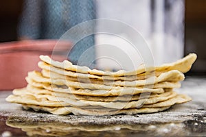 Stack of Flour Tortillas with Flour Bin in Background