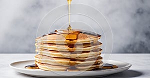 A stack of fluffy pancakes drizzled with maple syrup