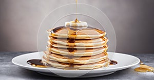 A stack of fluffy pancakes drizzled with maple syrup