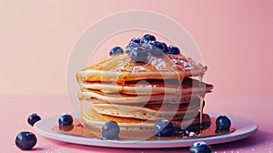 A stack of fluffy pancakes drizzled with sticky syrup and dotted with fresh blueberries providing a mouthwatering start