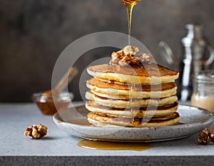 a stack of fluffy pancakes with maple syrup drizzle