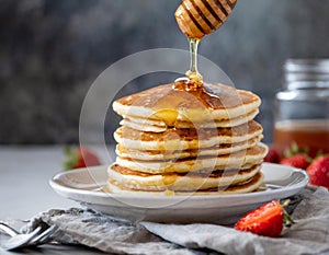 a stack of fluffy pancakes with maple syrup drizzle