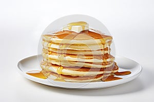 stack of fluffy pancakes with a pat of butter, honey or maple syrup on a white plate. Homemade pancakes for breakfast