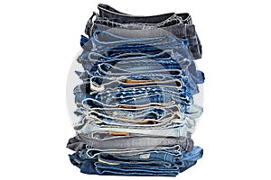 Stack of folded blue jeans pants, dark blue denim trousers showing waistbands.