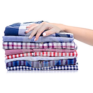 Stack folded casual shirt holding hand