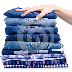Stack folded casual shirt and jeans holding hand