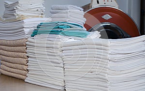 Stack of folded clean cloths in an industrial laundry