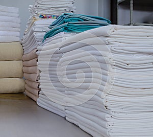 Stack of folded clean cloths in an industrial laundry