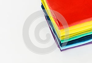 Stack of folded colorful t-shirt on white background