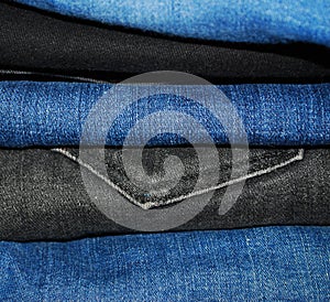 A stack of folded denim pants close-up