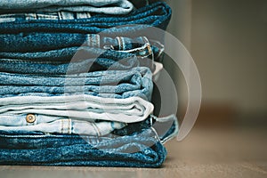 Stack of folded denim pants. Fashion, style, stock and store concept.