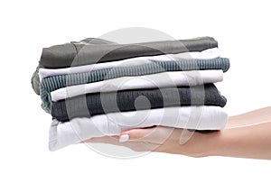 Stack folded green white clothing in hand