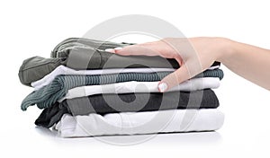 Stack folded green white clothing in hand