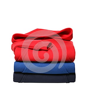 Stack of folded hooded sweat shirts isolated on white background photo
