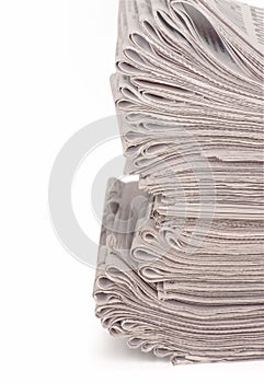 A stack of folded newspapers