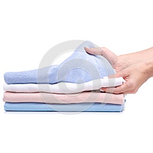 Stack folded shirt clothing, pastel color hand holding