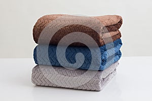 Stack of folded soft blankets isolated