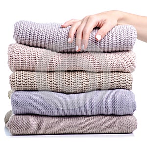 Stack folded sweater clothing hand holding