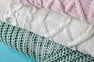 Stack of folded warm sweaters, closeup