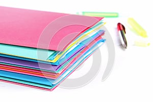 Stack of folders containing work documents in different colors
