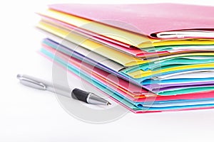 Stack of folders containing work documents in different colors