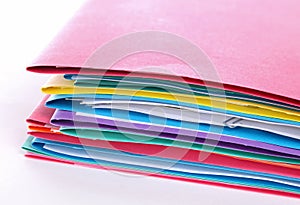 Stack of folders containing work documents in different colors