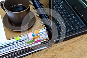 Stack of folders and documents with coffee