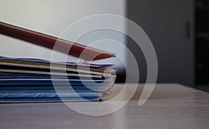 A stack of folders with documents on the table