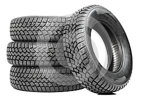 Stack of four car wheel winter tires isolated