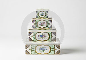 Stack of four decorative floral patterned storage boxes