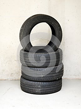 Stack of four old used vehicle tyres