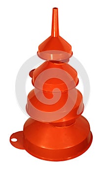 Stack of four orange plastic funnels isolated on a white background