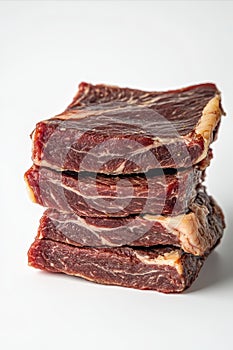 Stack of Four Raw Uncooked Beef Steaks Isolated on White