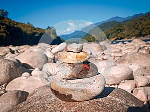 Stack of four stones with beautiful scenery background