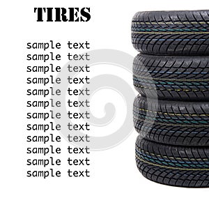 Stack of four wheel new black tyres for winter car driving isolated on white background