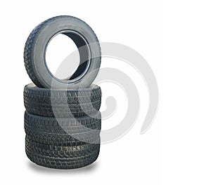 Stack of four wheel new black winter tyres