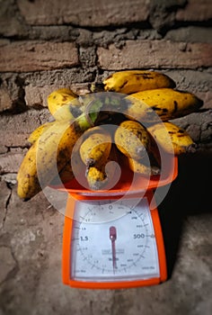 a stack of fresh bananas being weighed
