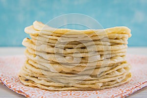 Stack of Fresh Flour Tortillas on Orange Cloth