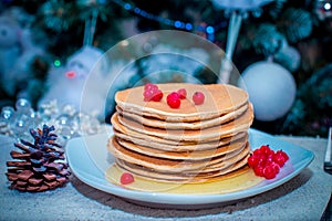 Stack of fresh golden pancakes or flapjacks topped