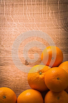 Stack of fresh orange fruits on wooden table with