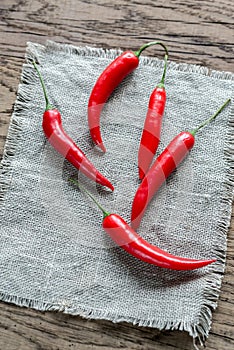 Stack of fresh red chili peppers on the burlap