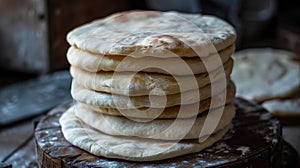 Stack of freshly baked flatbread on a wooden surface