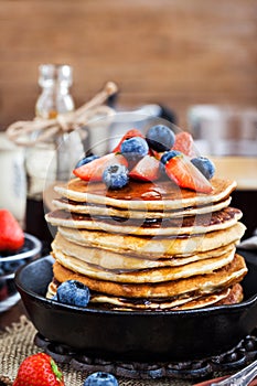 Stack of freshly prepared banana pancakes with fresh berries