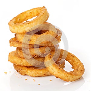 Stack of fried onion rings isolated on white background photo