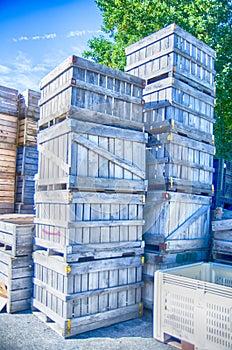Stack fruit boxes or crates sit outside a warehouse