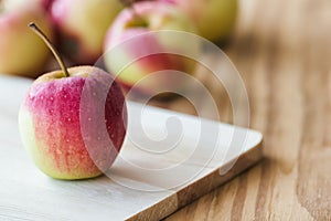 Stack of fuji apple and on cutting board put on wood table for b