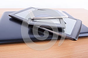 Stack of gadgets on an office desk