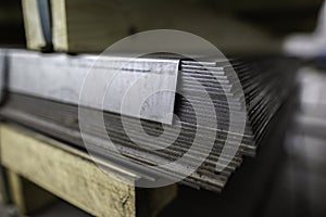 a stack of galvanized thick hot rolled steel sheets in a warehouse